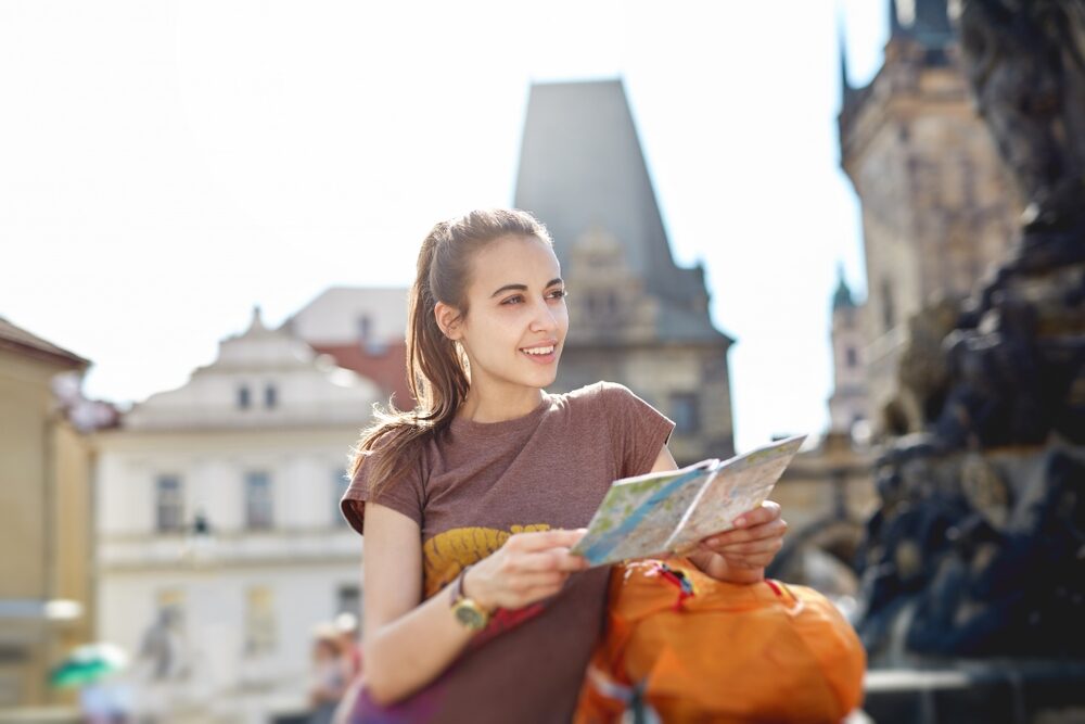 A,Young,Smiling,Woman,Tourist,In,Sportswear,And,Small,Orange
